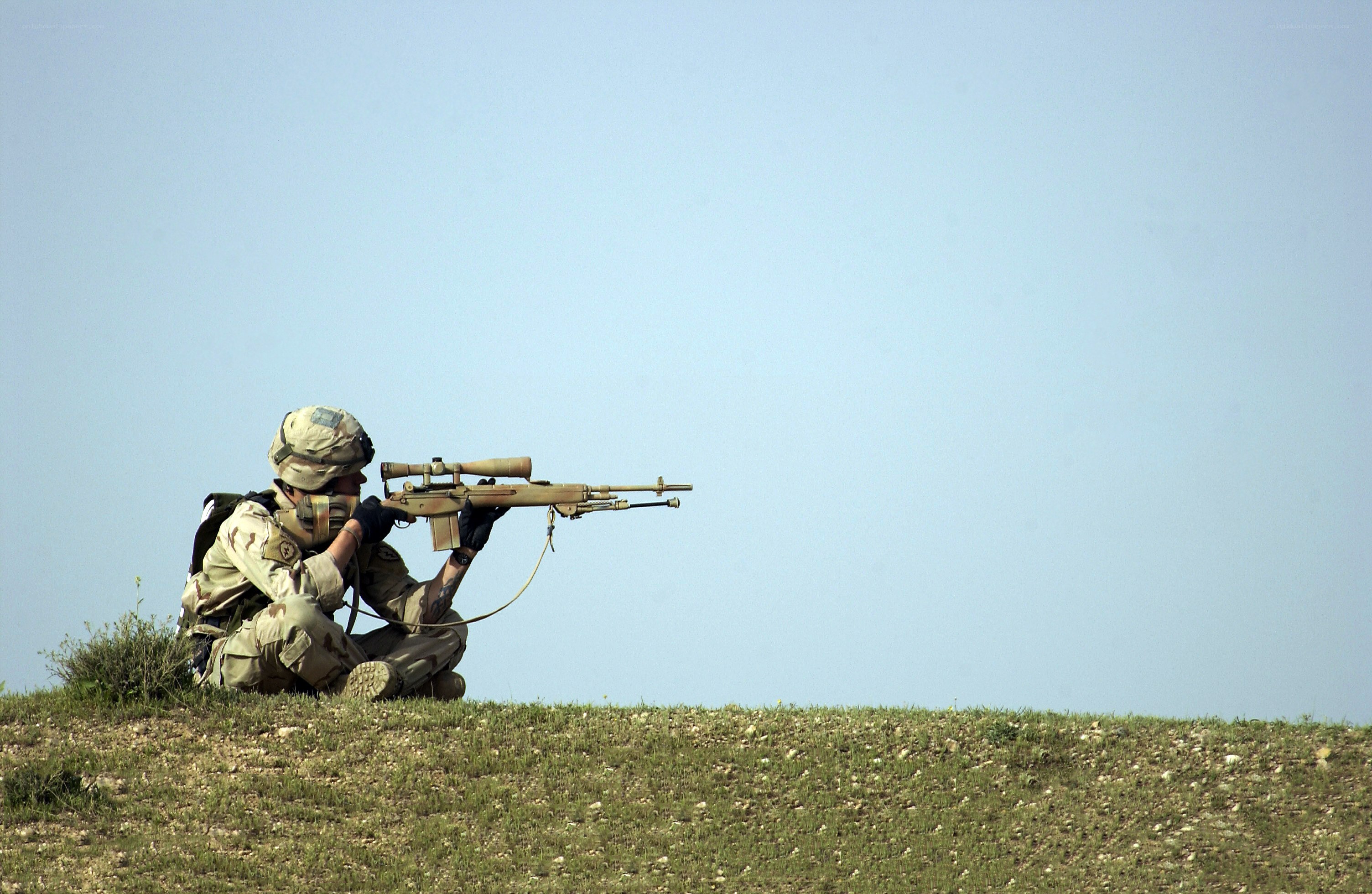 soldier aiming rifle on hill