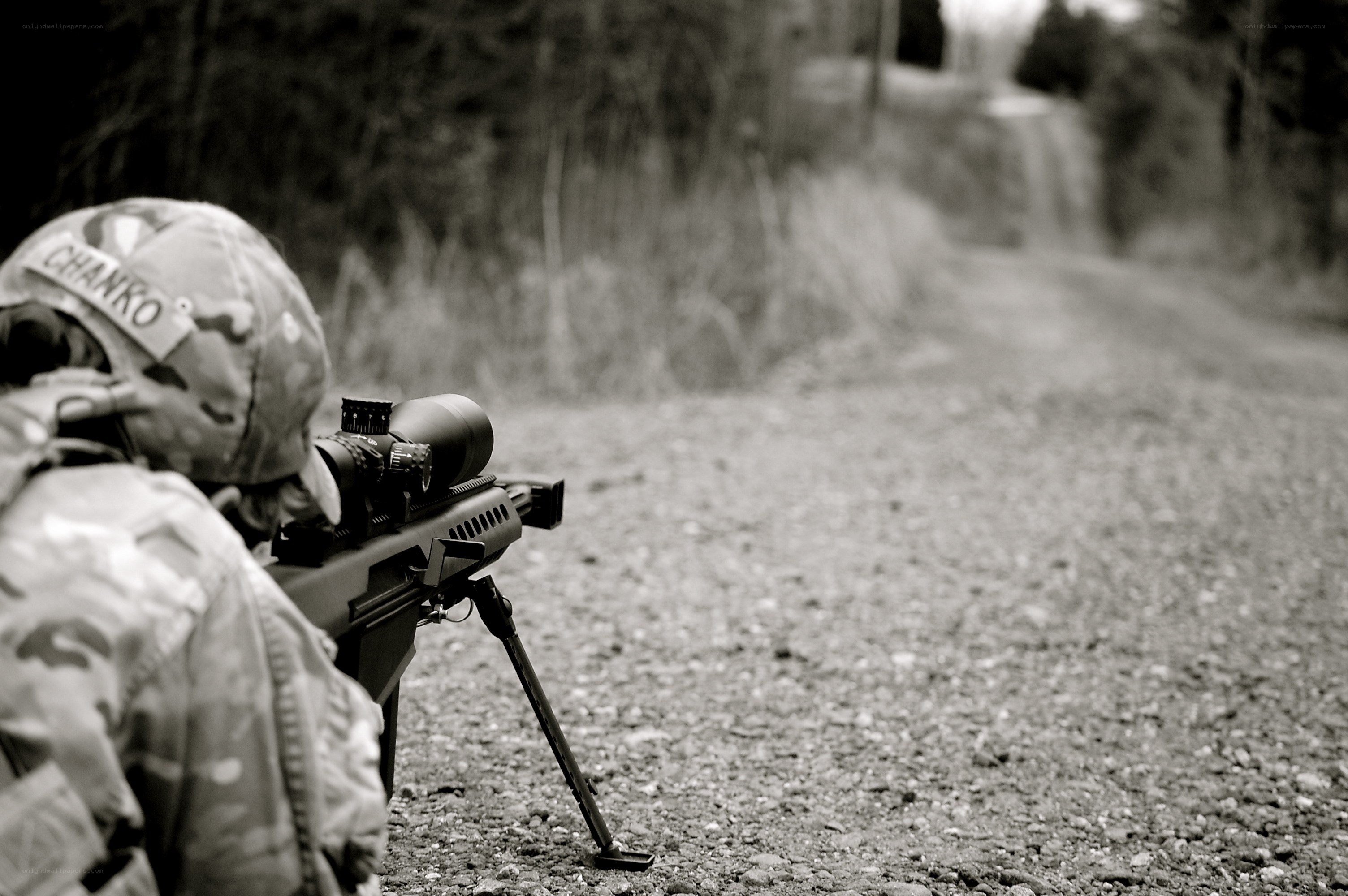 soldier aiming rifle on road