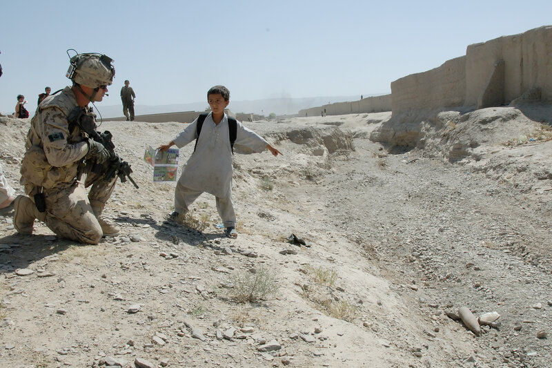 Soldier and boy in conflict zone