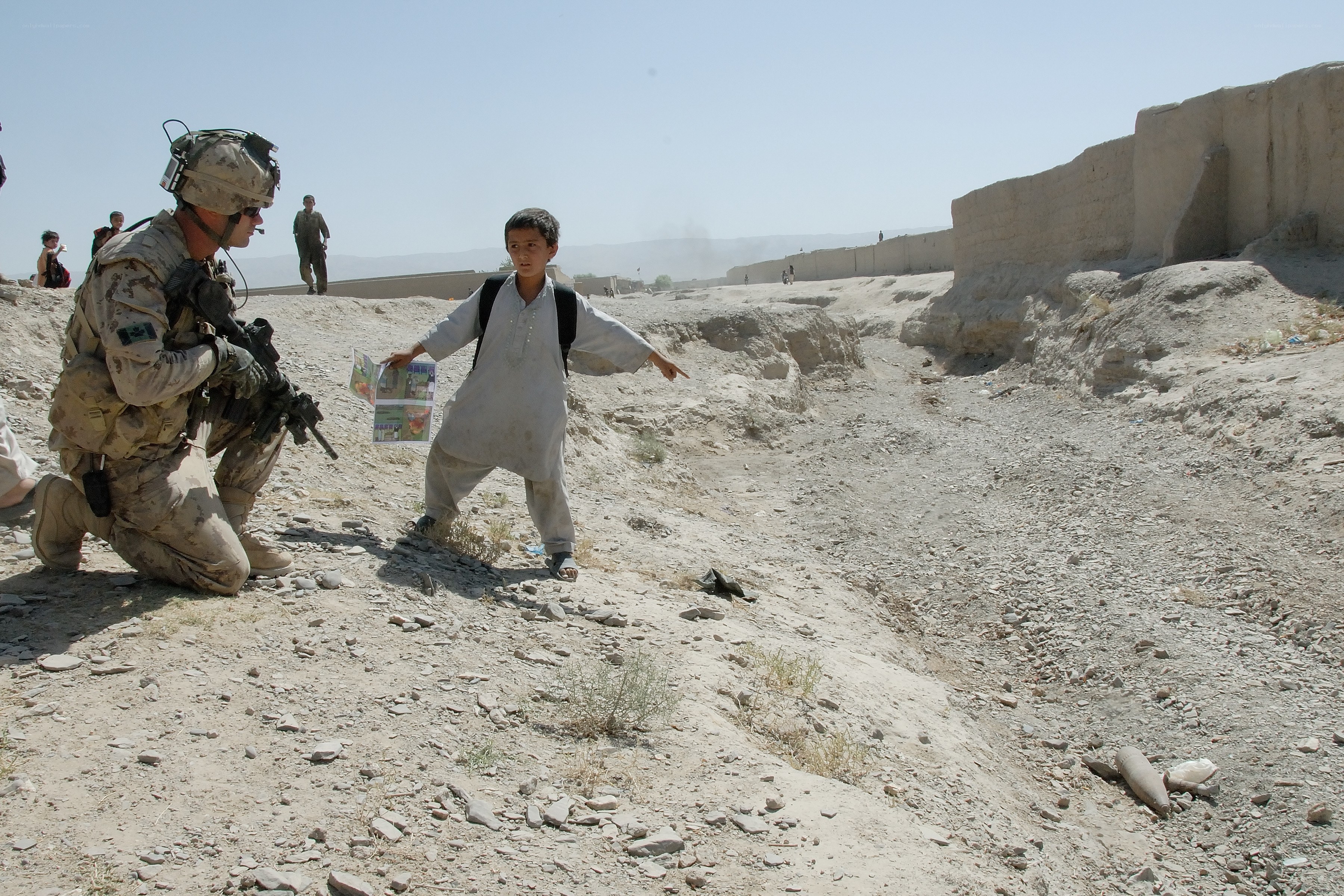 Soldier and boy in conflict zone