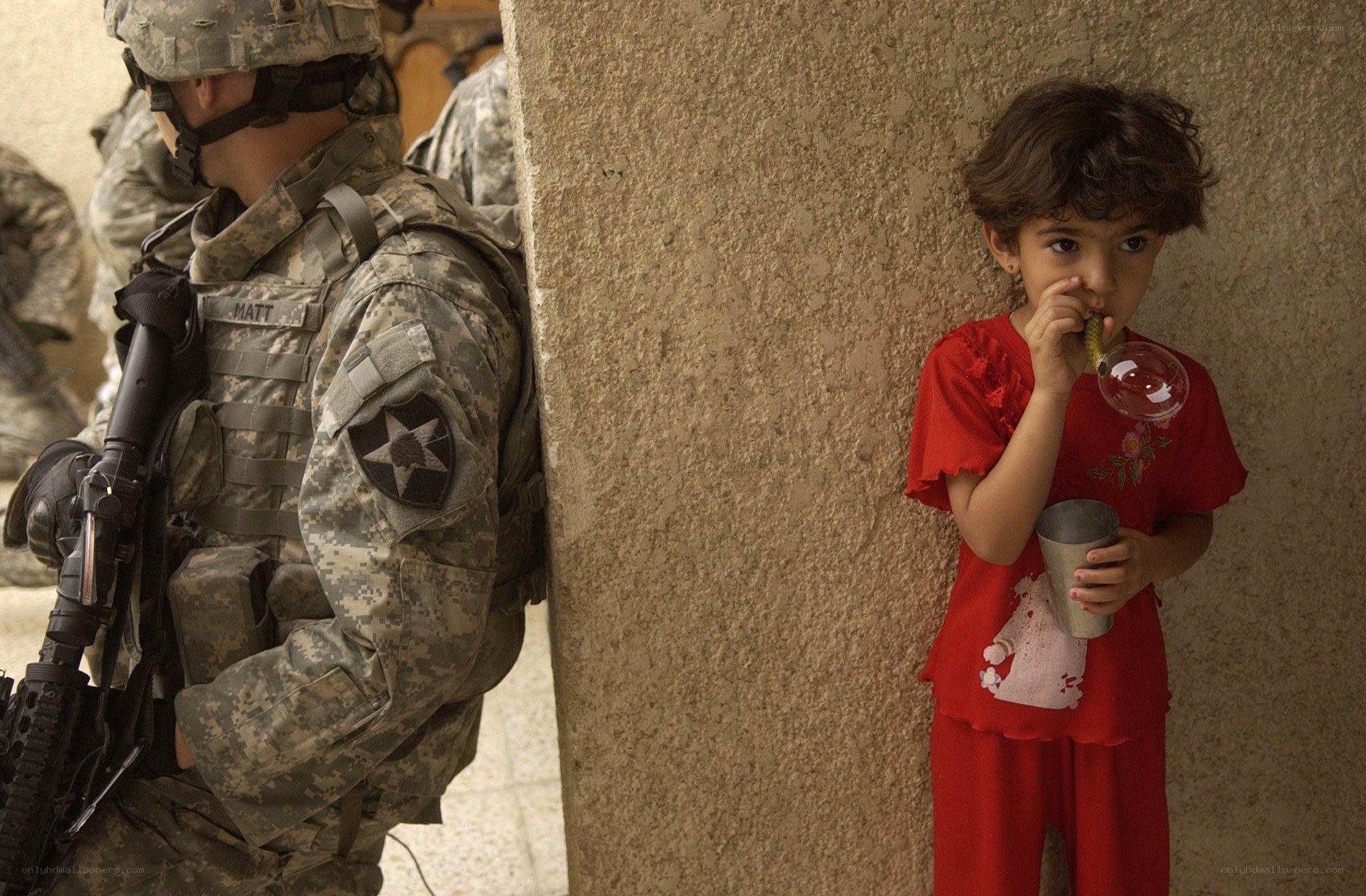 Soldier and child in conflict zone