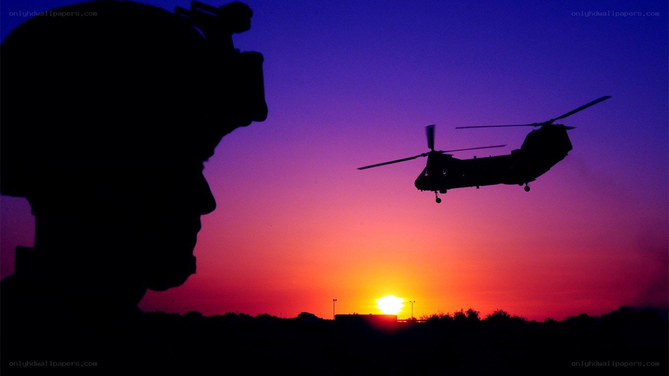 Soldier and helicopter at sunset