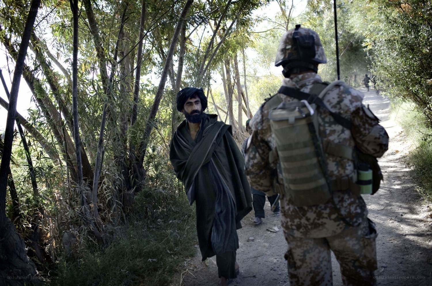 Soldier and man on forest path