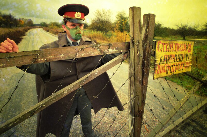 Soldier at barbed wire gate