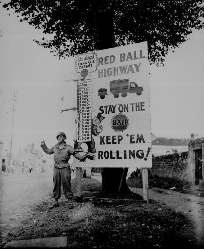 Soldier at Red Ball Highway sign