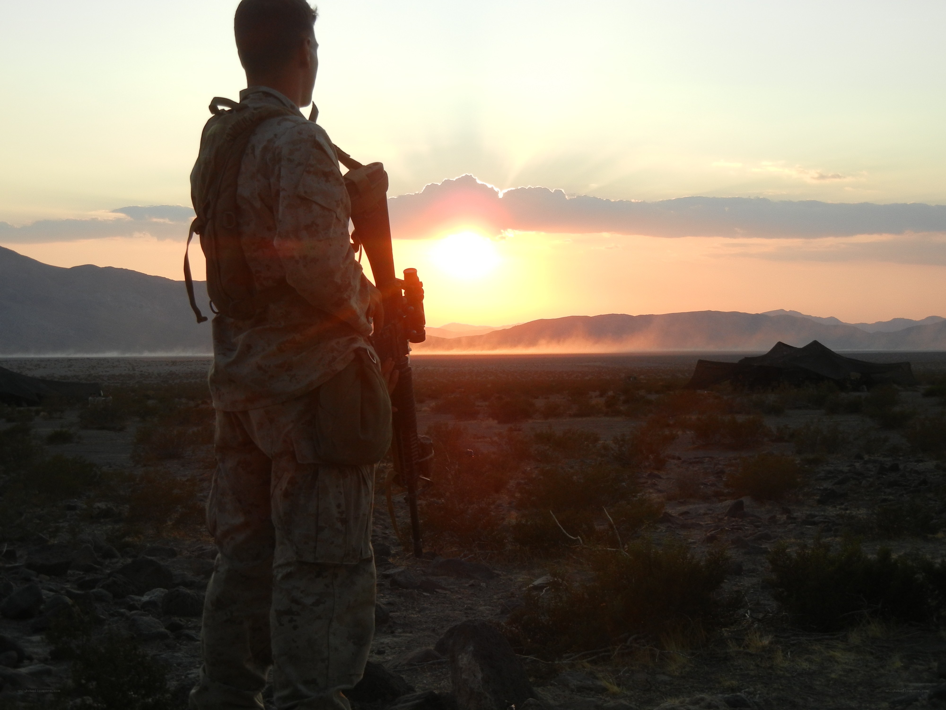 Soldier at sunset in desert