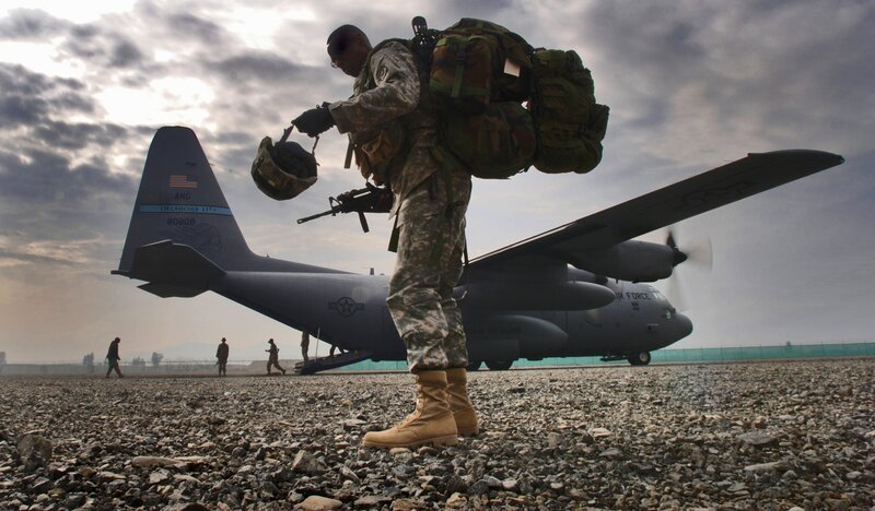 Soldier boarding military transport plane