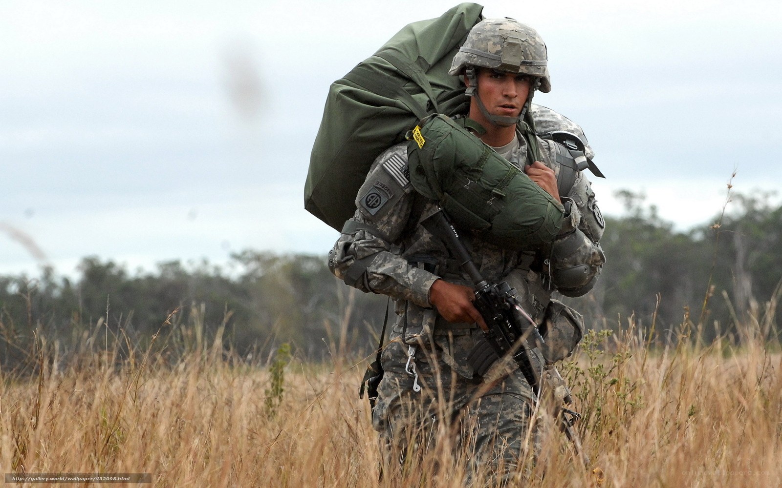 Soldier carrying gear in field