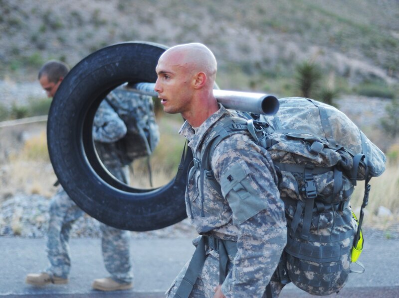 Soldier carrying tire and gear