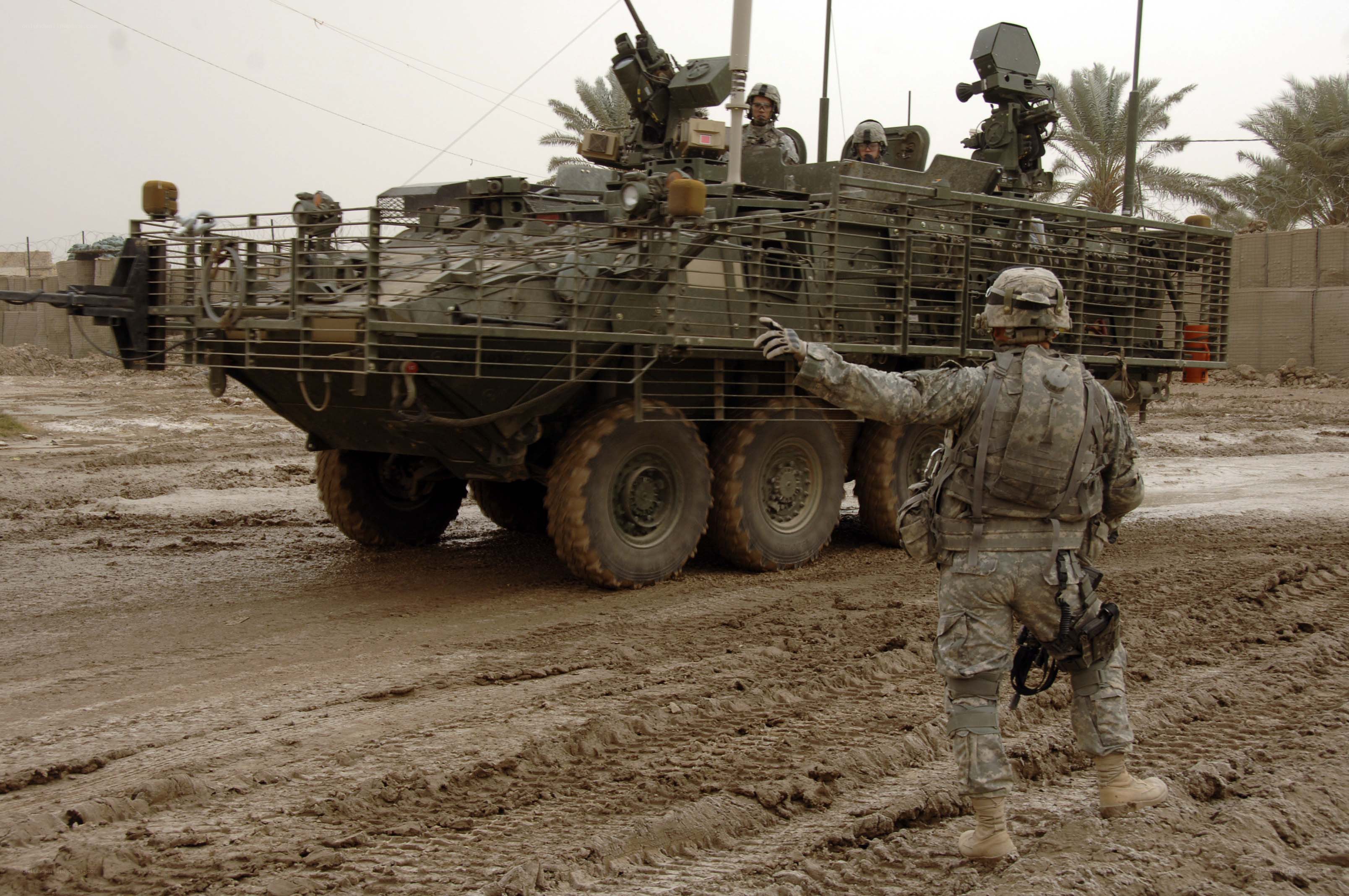 Soldier directing armored vehicle