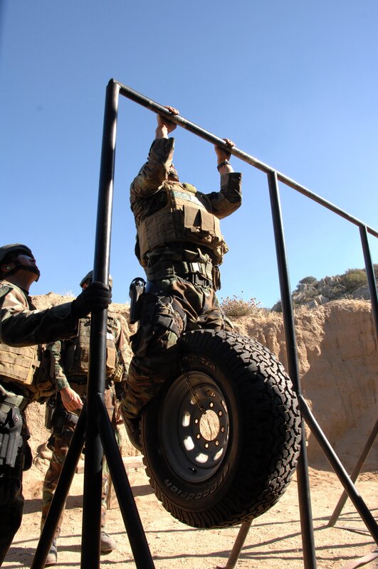 Soldier doing pull-ups with tire