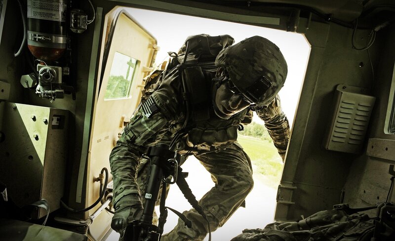 Soldier exiting military vehicle