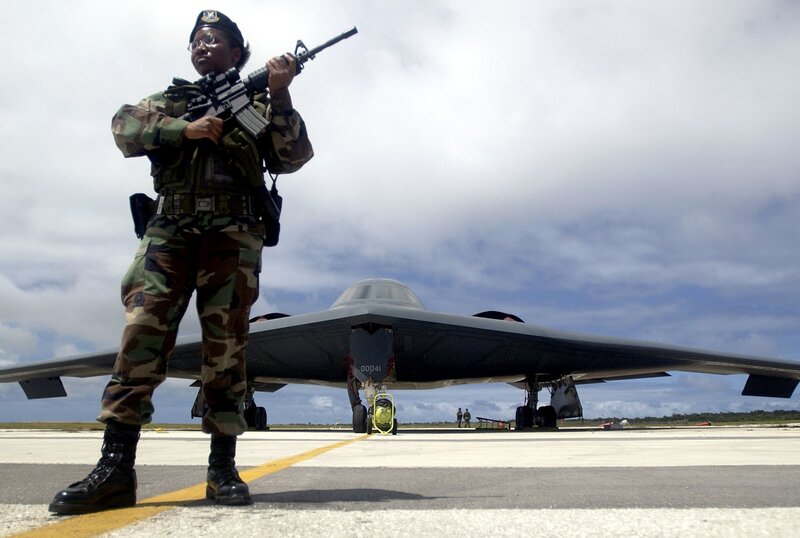 Soldier guarding stealth bomber