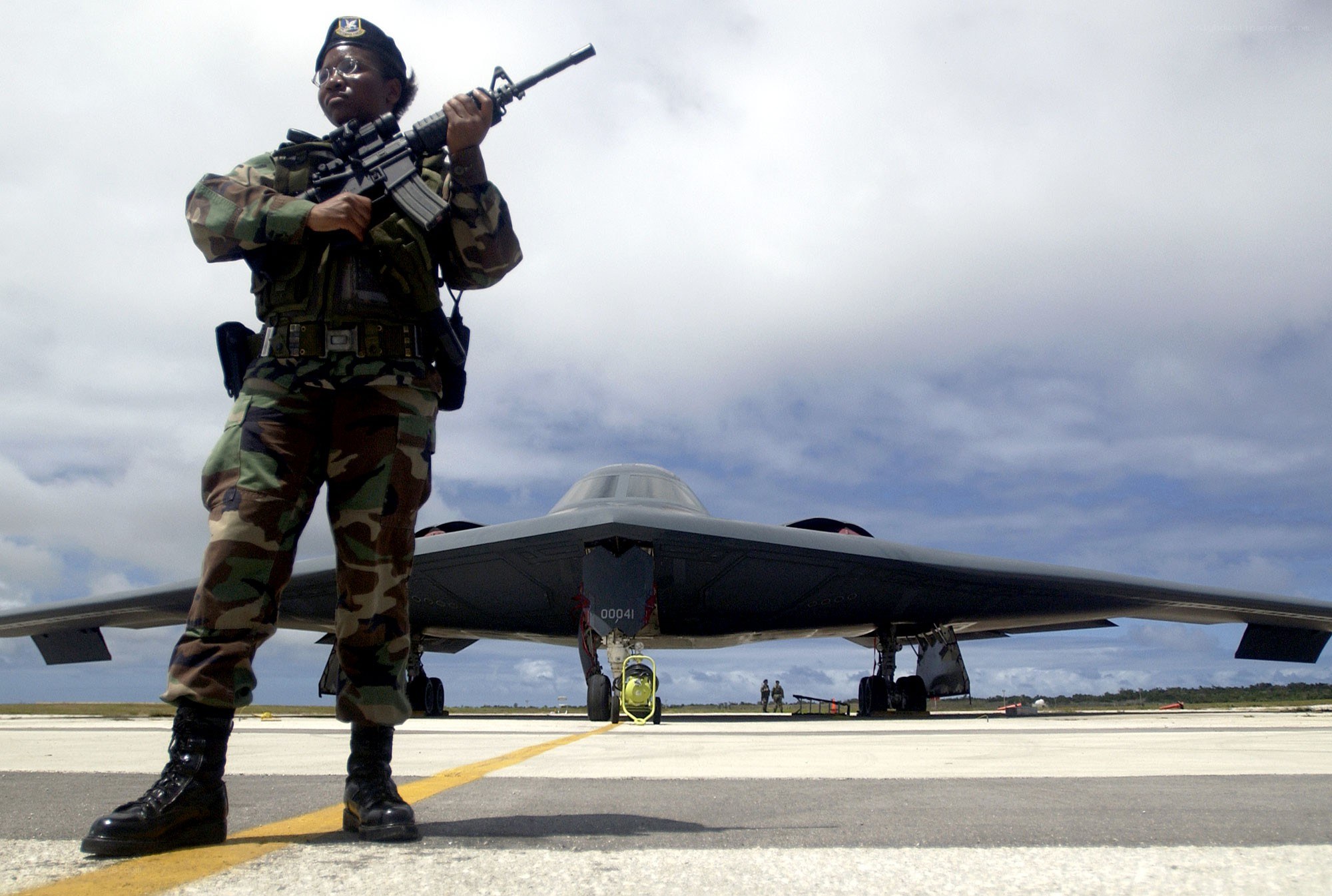 Soldier guarding stealth bomber