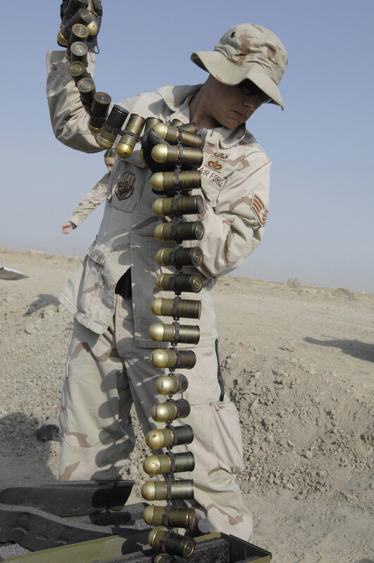 Soldier handling ammunition belt