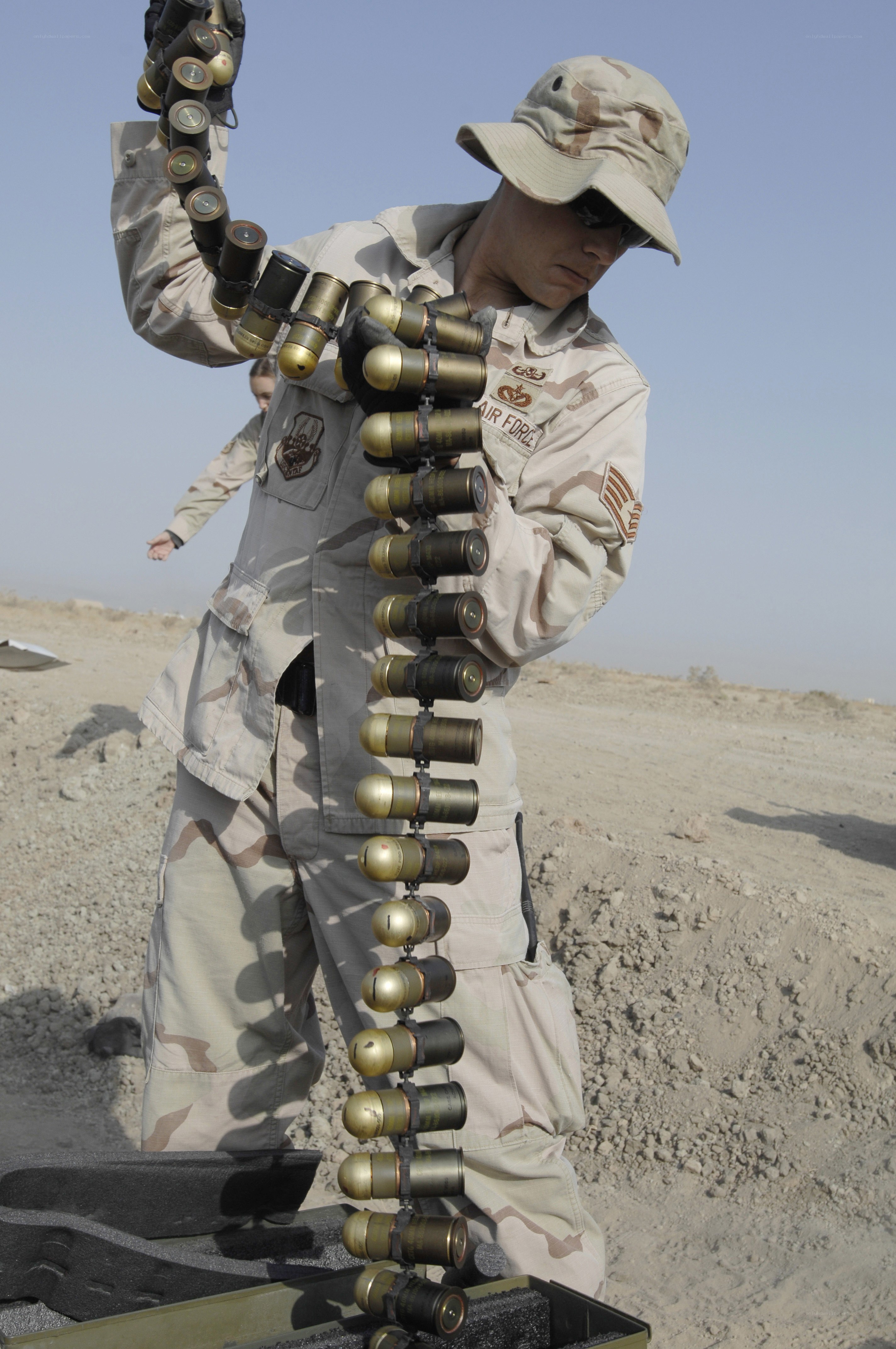 Soldier handling ammunition belt