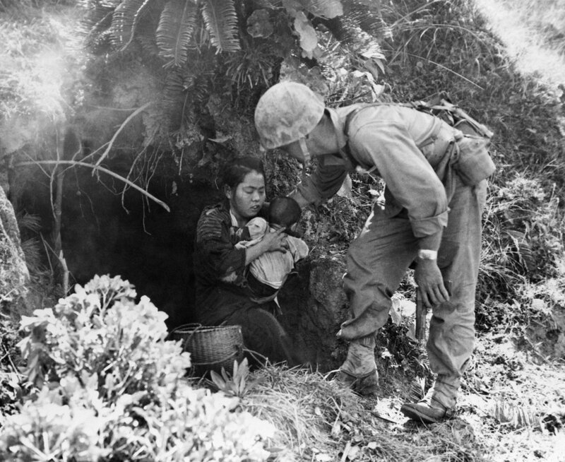 Soldier helping a woman in a bunker