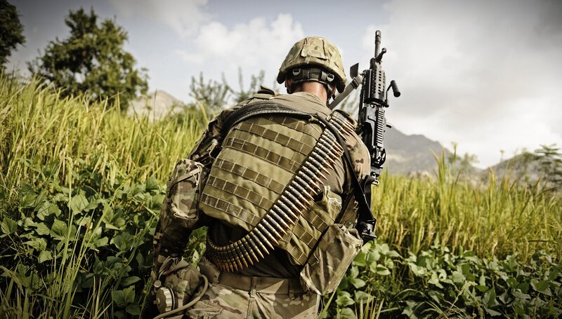 Soldier in a field with rifle
