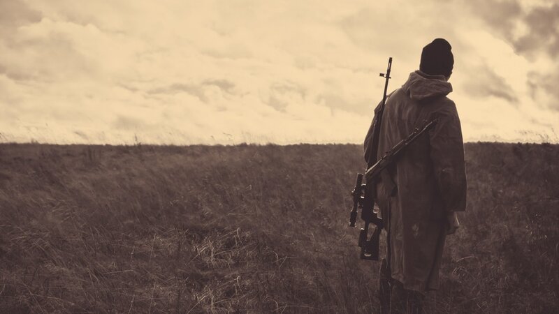 Soldier in a field with rifle