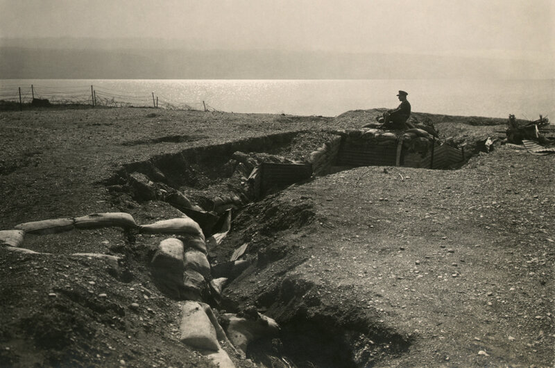 Soldier in a trench by the sea