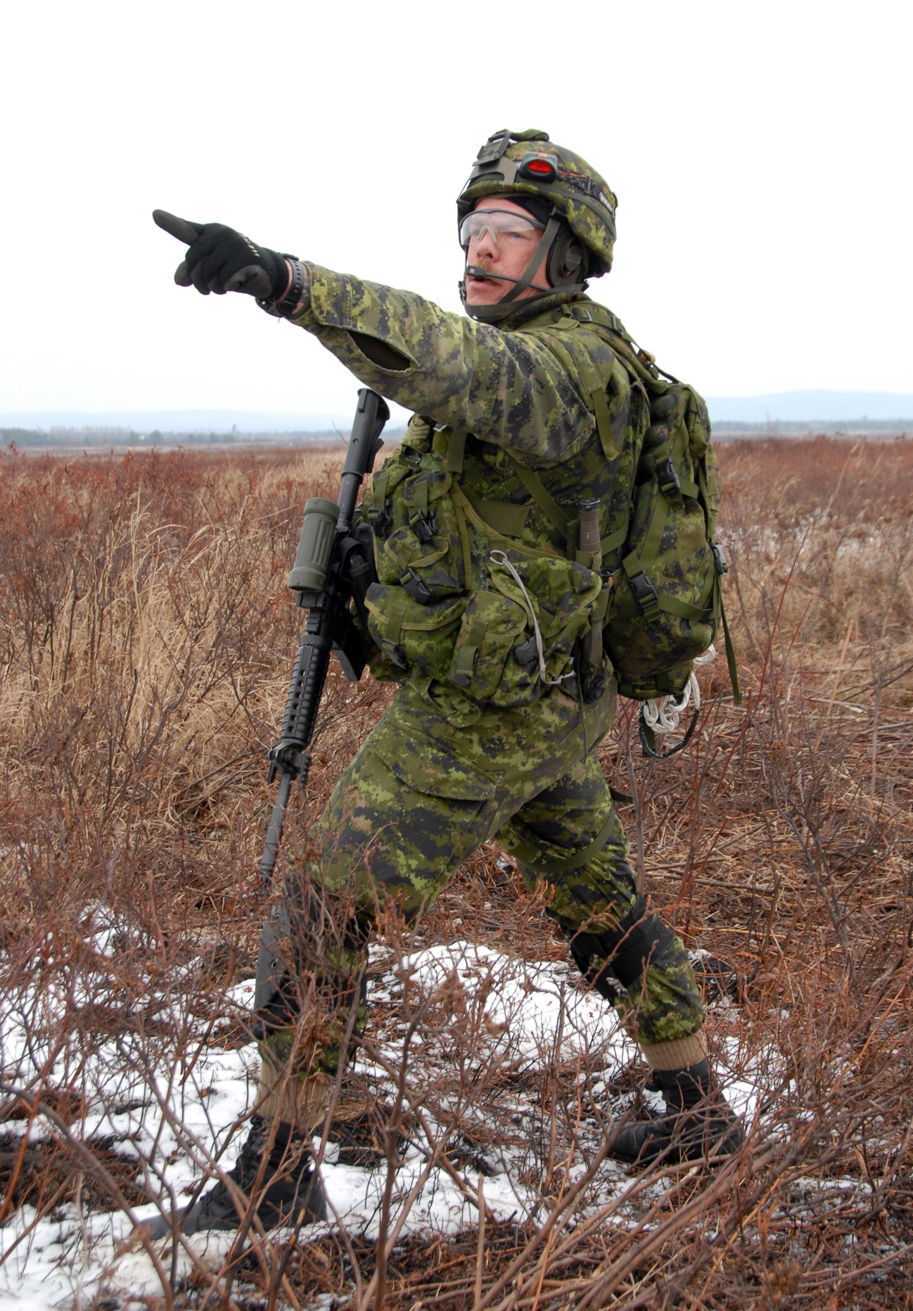 Soldier in camouflage pointing