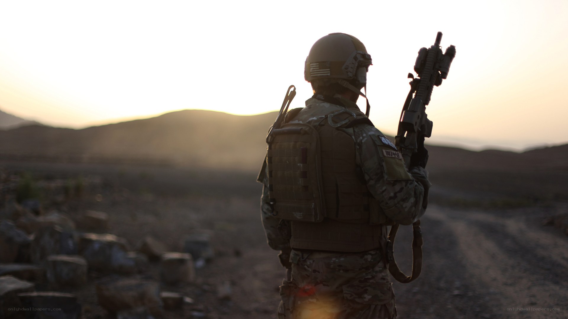 Soldier in desert at sunset