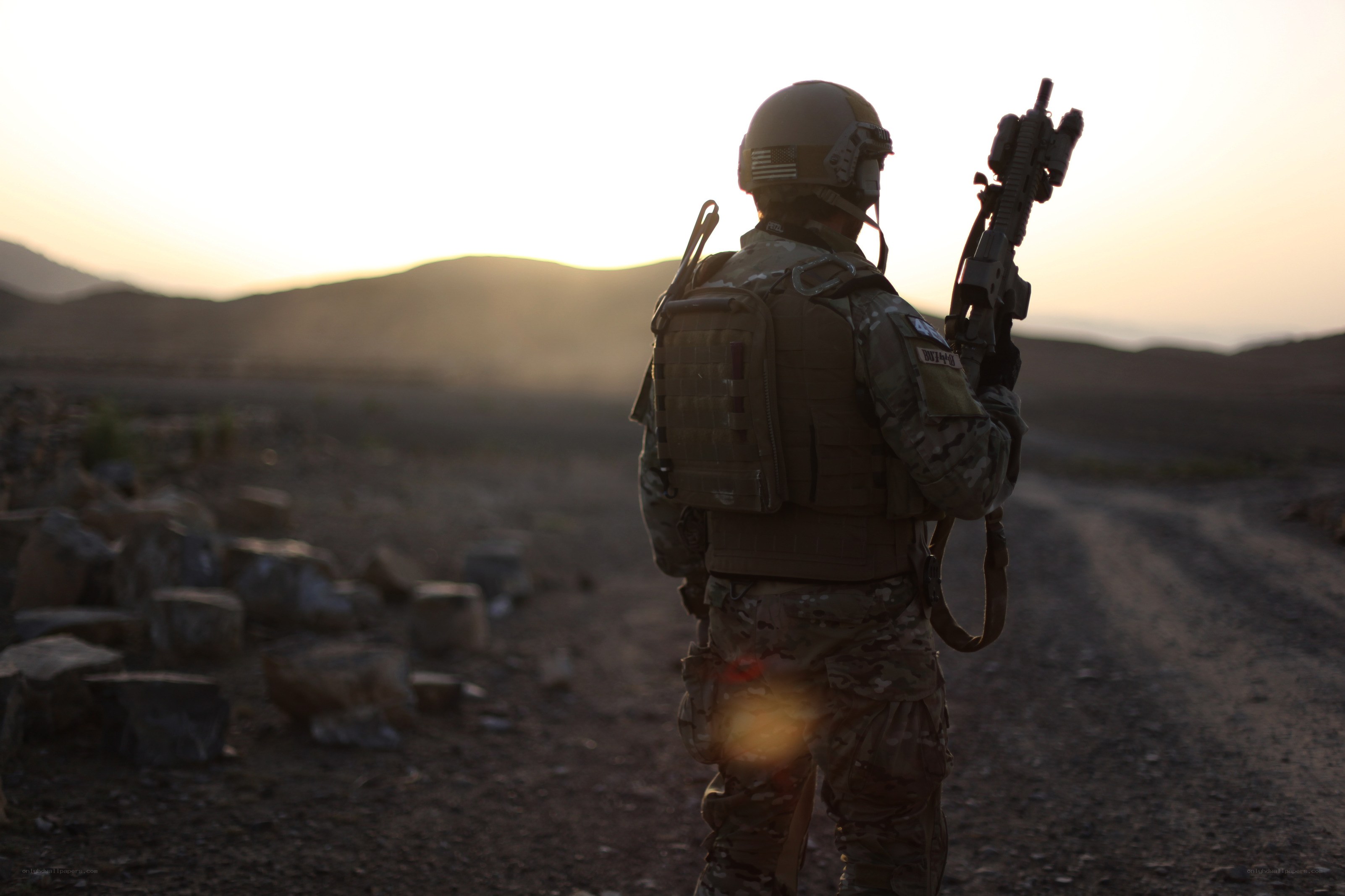 Soldier in desert at sunset