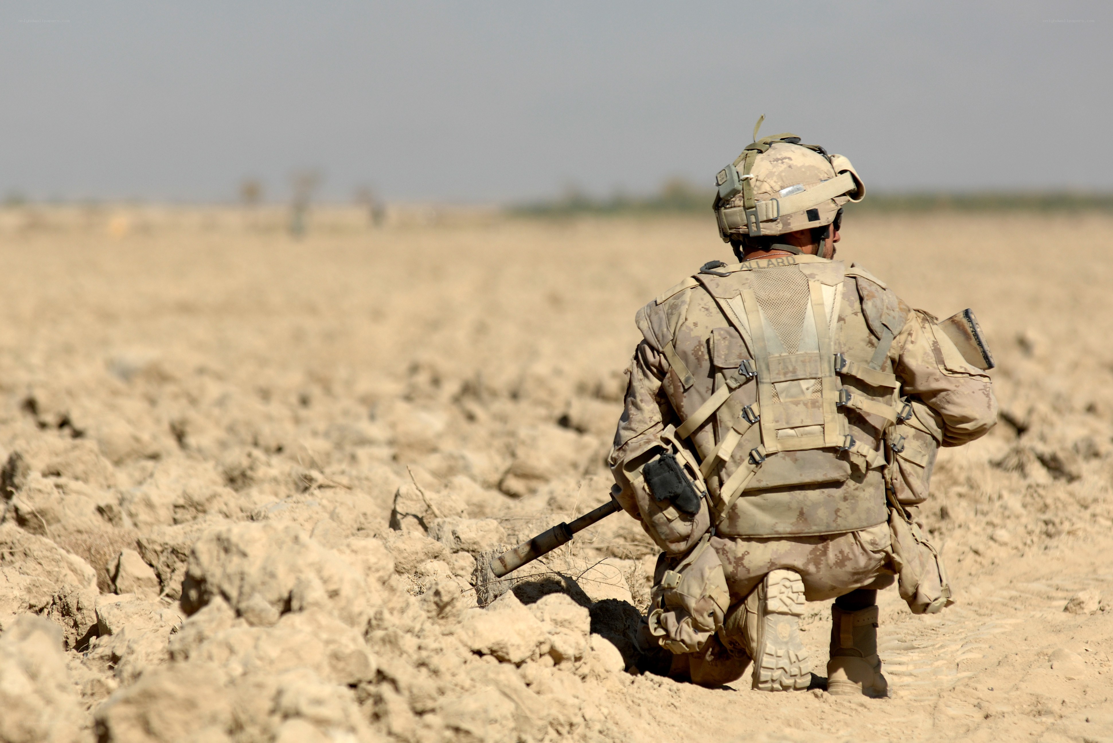 Soldier in desert terrain