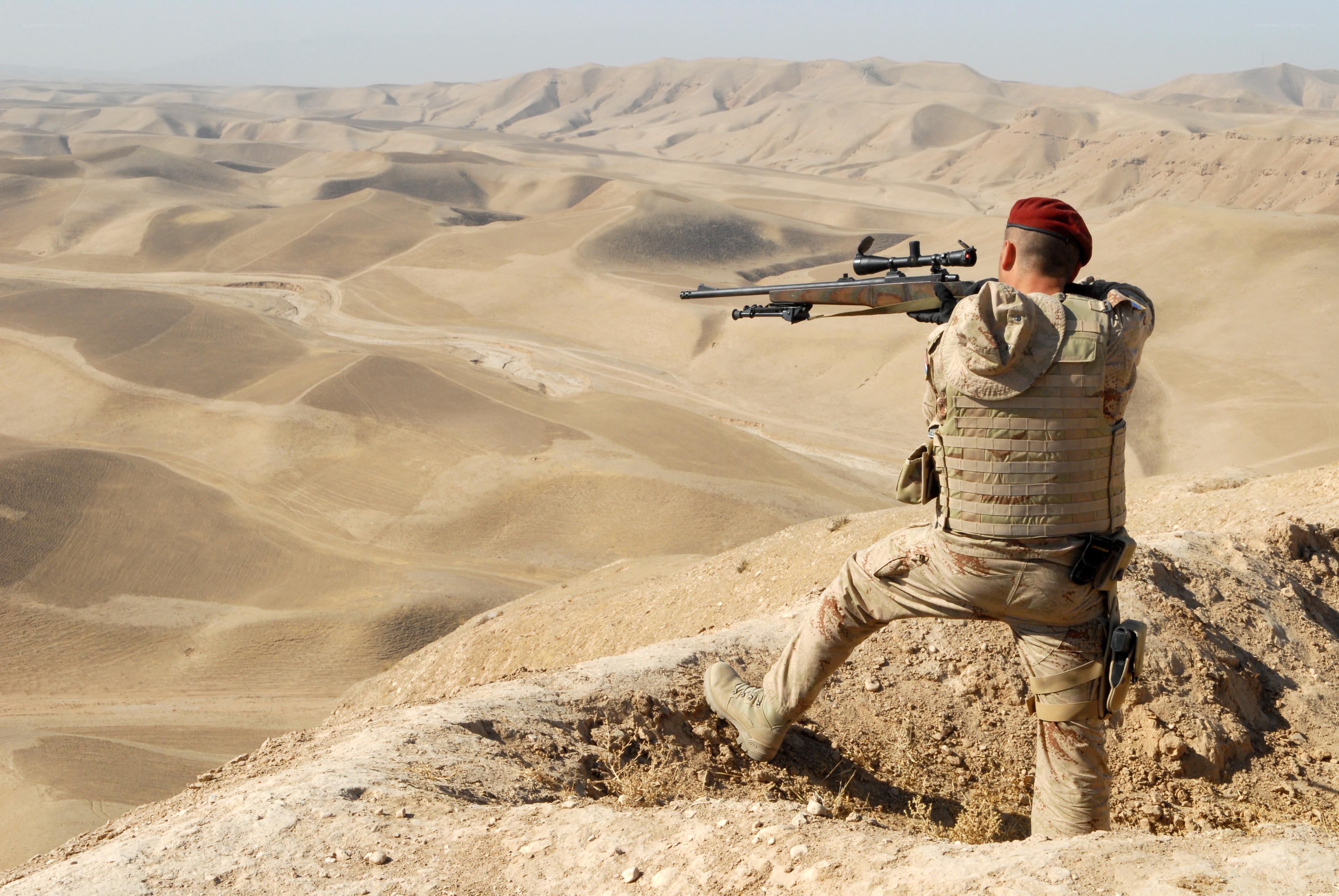 soldier in desert terrain