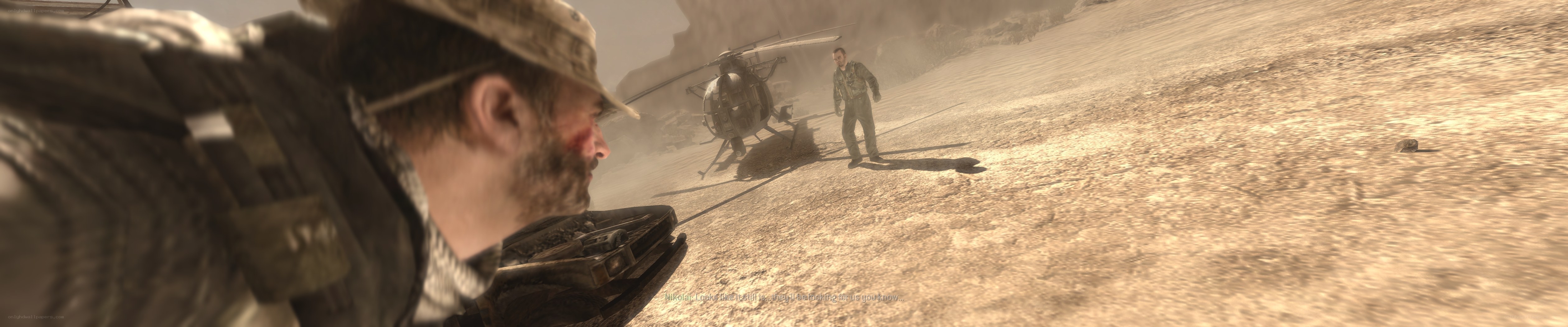 Soldier in desert with helicopter