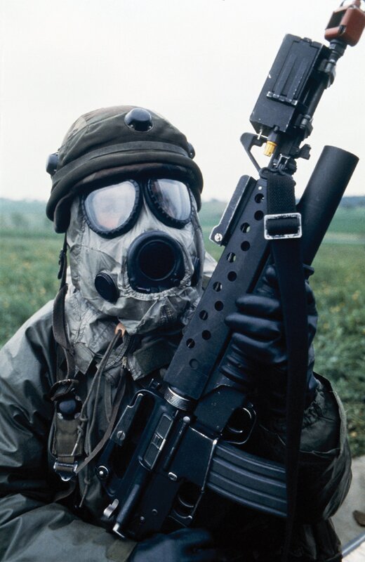 Soldier in gas mask with rifle
