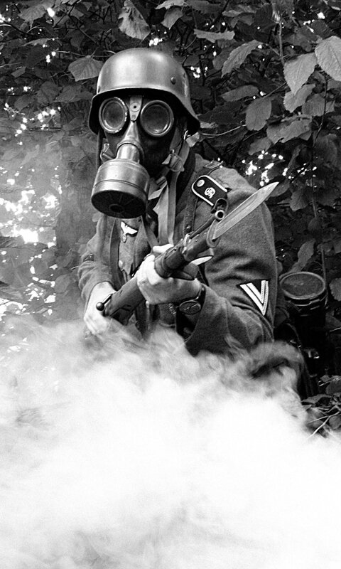 Soldier in gas mask with rifle