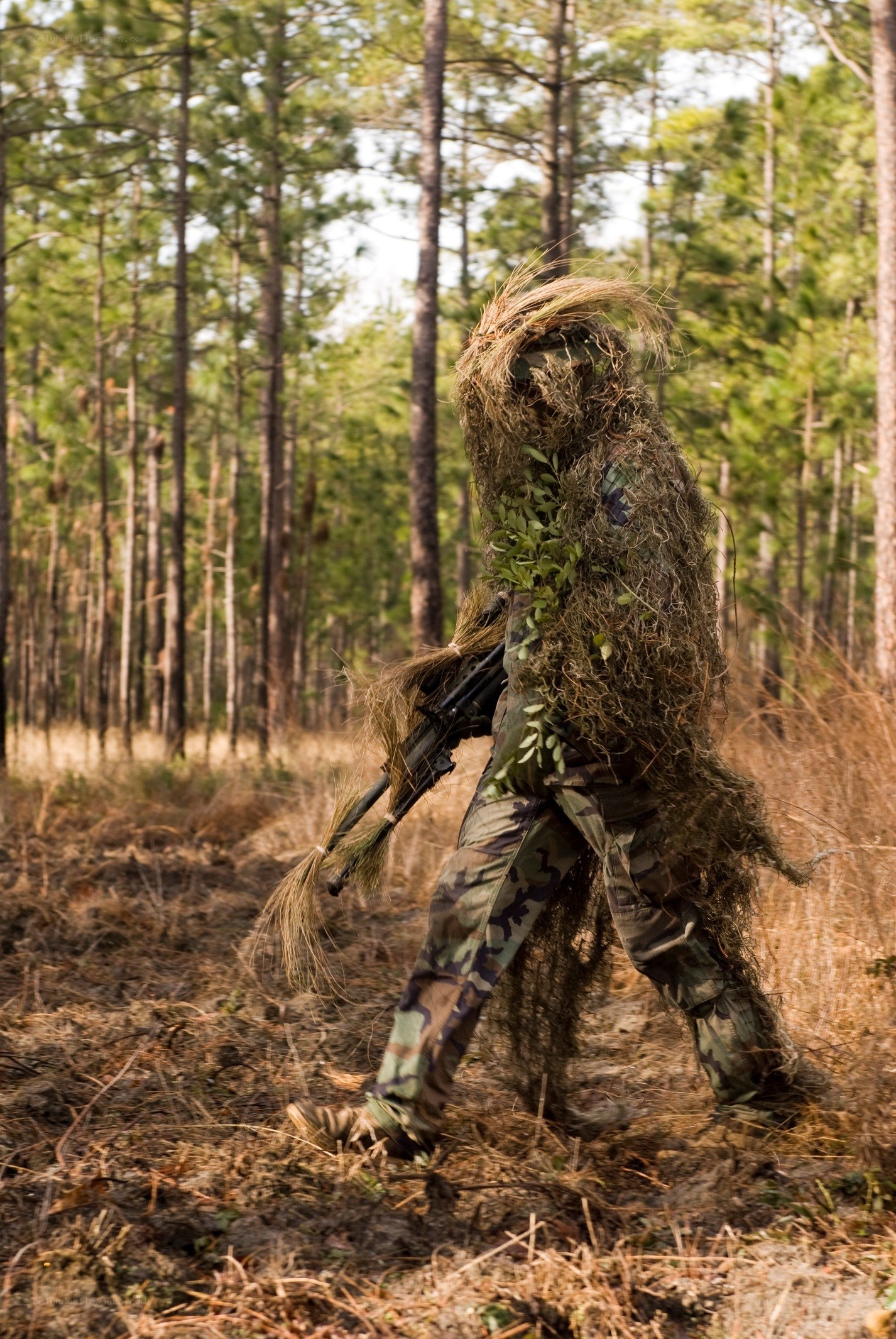 soldier in ghillie suit walking