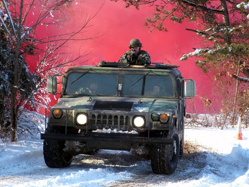 Soldier in Humvee with red smoke