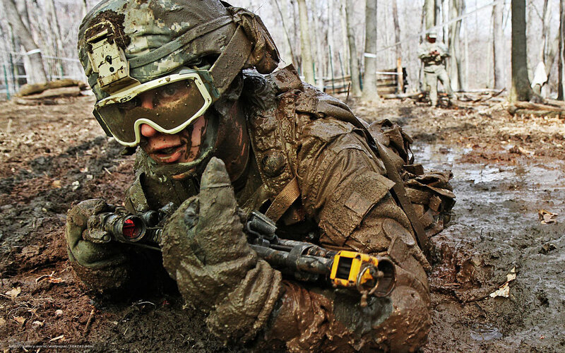 Soldier in muddy training exercise