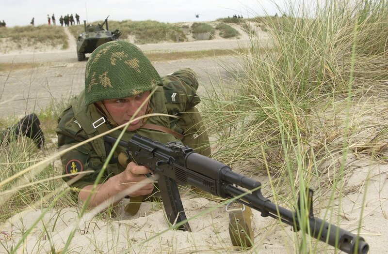 Soldier in sand dune with rifle