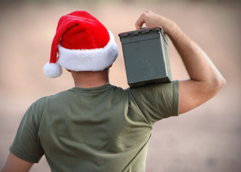 Soldier in Santa hat carrying ammo