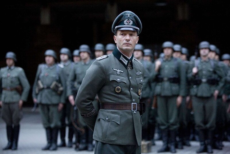 Soldier in uniform with troops