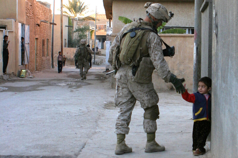 Soldier interacting with child in alley