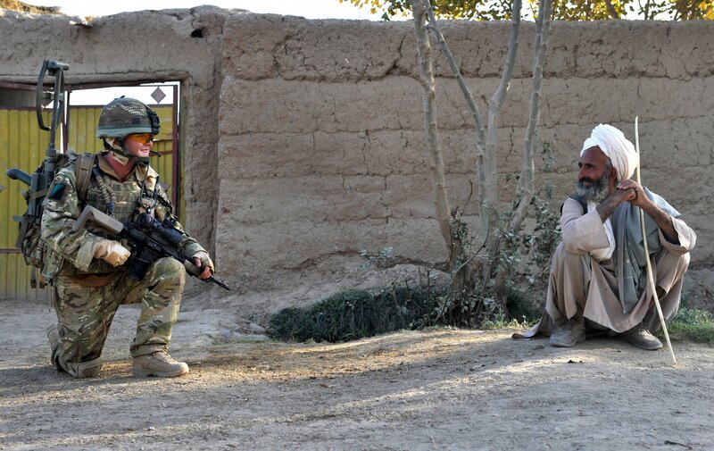 Soldier interacting with local man