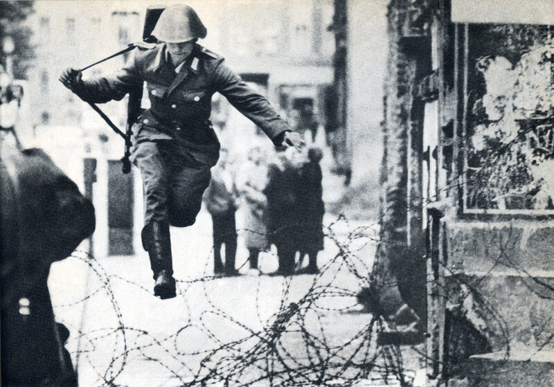Soldier jumping over barbed wire