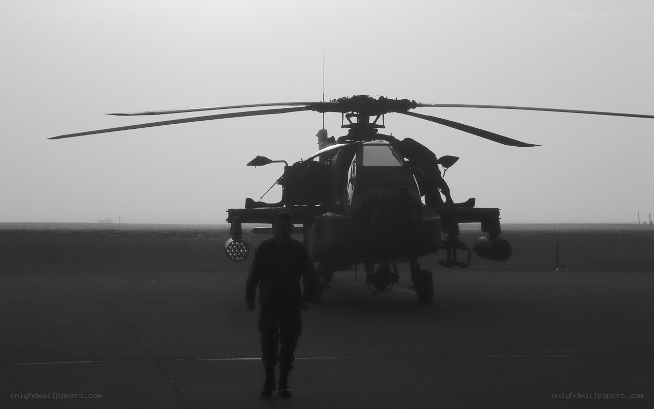 soldier near attack helicopter