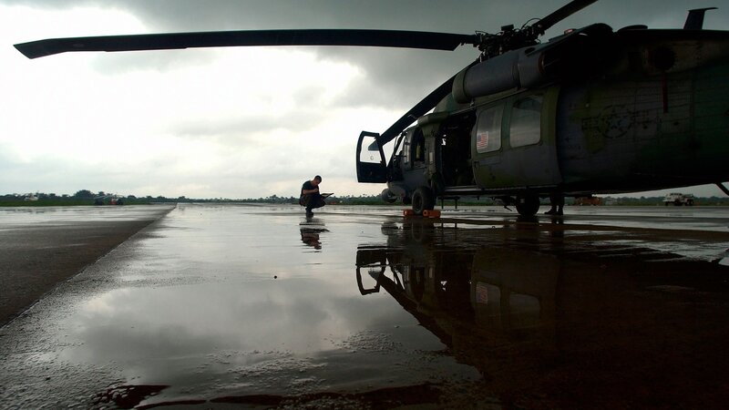 Soldier Near Helicopter — Gray, Dramatic
