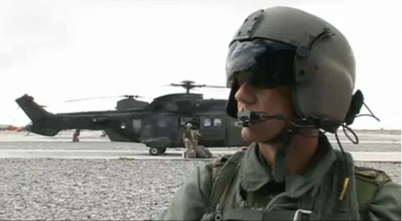Soldier near helicopter on tarmac