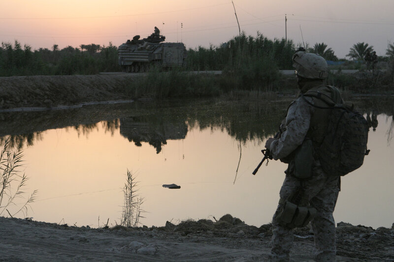 Soldier near water at dusk