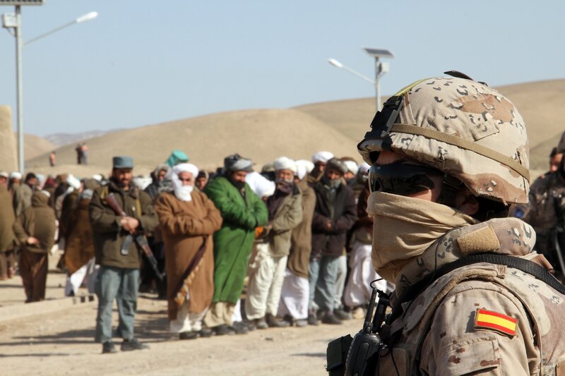 Soldier observing a line of men