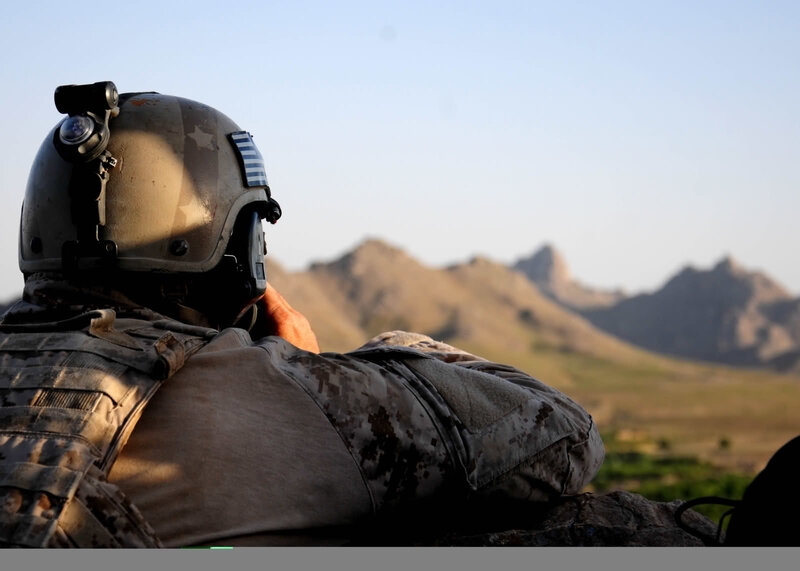 Soldier observing mountainous terrain