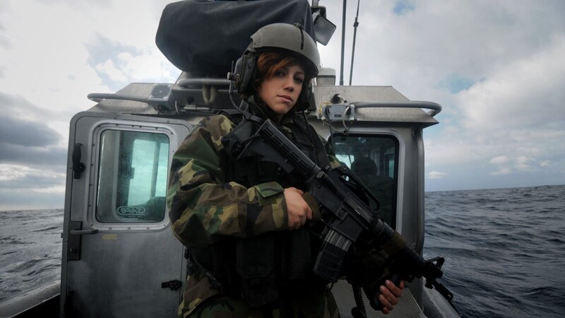 Soldier on a boat with rifle