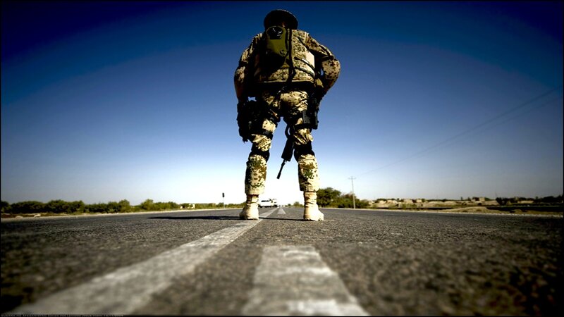 Soldier on a desert road