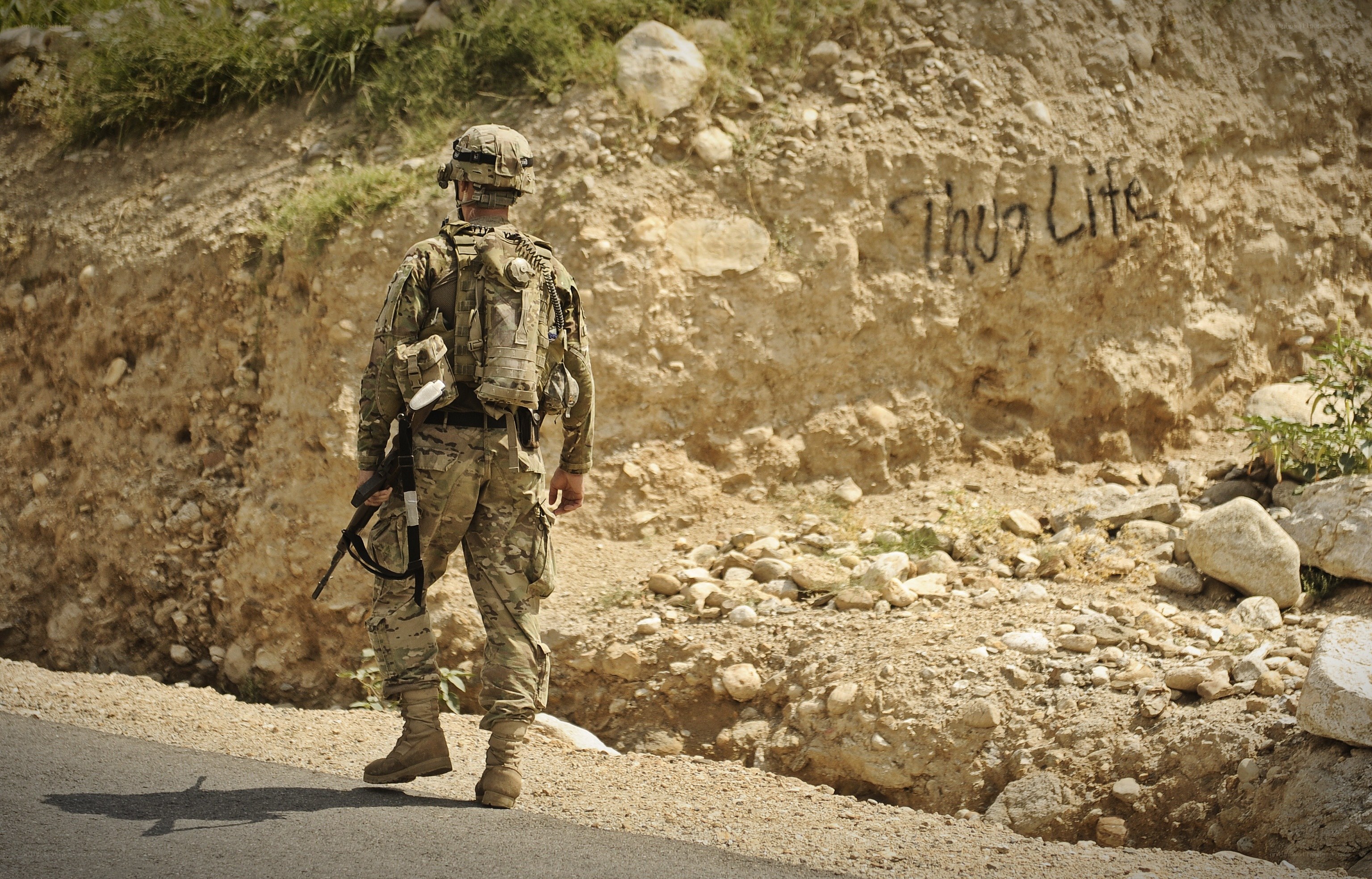 Soldier on a road with graffiti